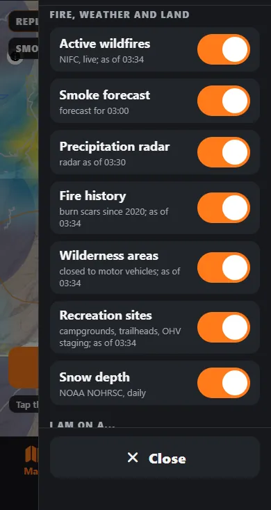 The Fire, weather and land section of the map layers panel with switches for active wildfires, smoke forecast, precipitation radar, fire history, wilderness areas, recreation sites and snow depth, each showing its source and as-of time.